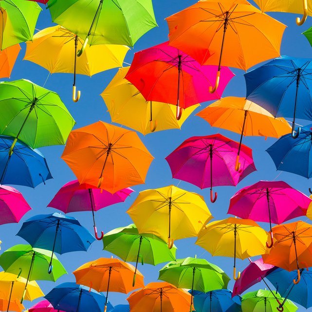 Schmuckbild Farbige Regenschirme schweben in der Luft